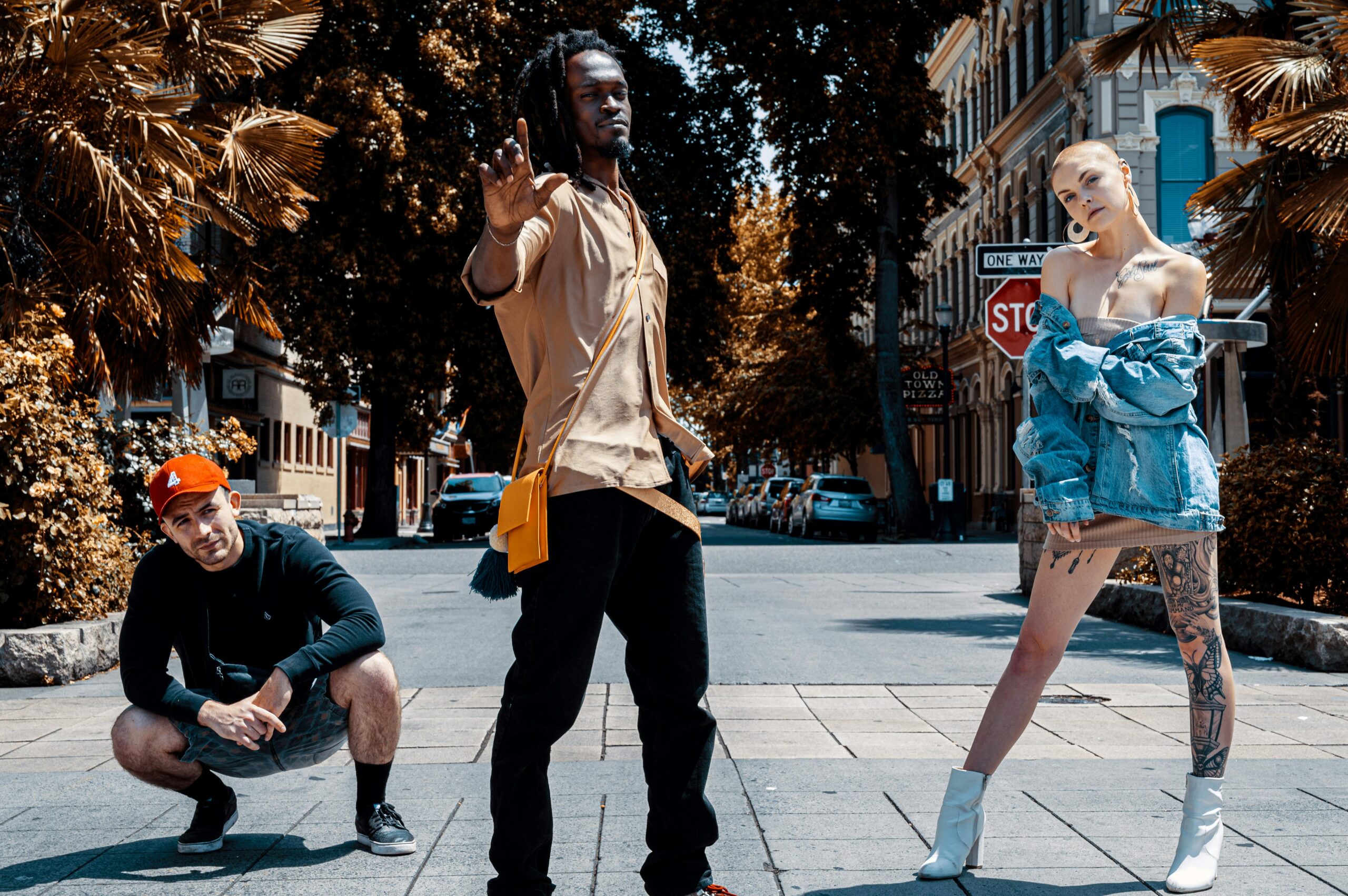 Outdoor fashion shoot featuring stylish models posing confidently in an urban setting.